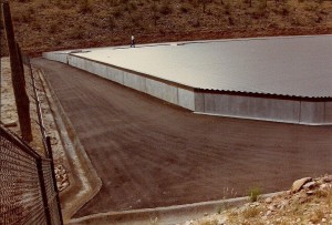 A large concrete building next to a mountain constructed by MGC Contractors.