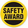 A yellow and black safety award badge on a white background ABOUT MGC CONTRACTORS.