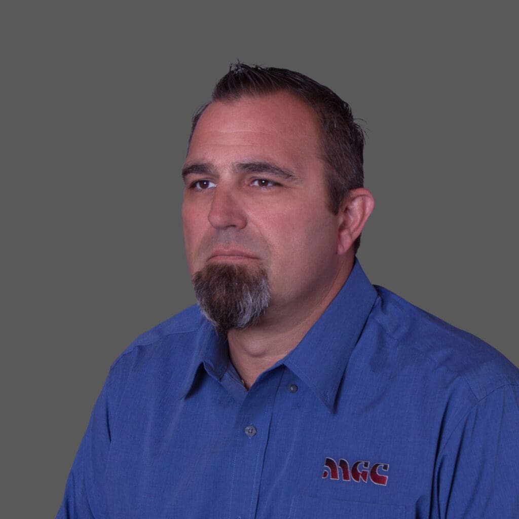 A man in a blue shirt with a beard who works for MGC Contractors.