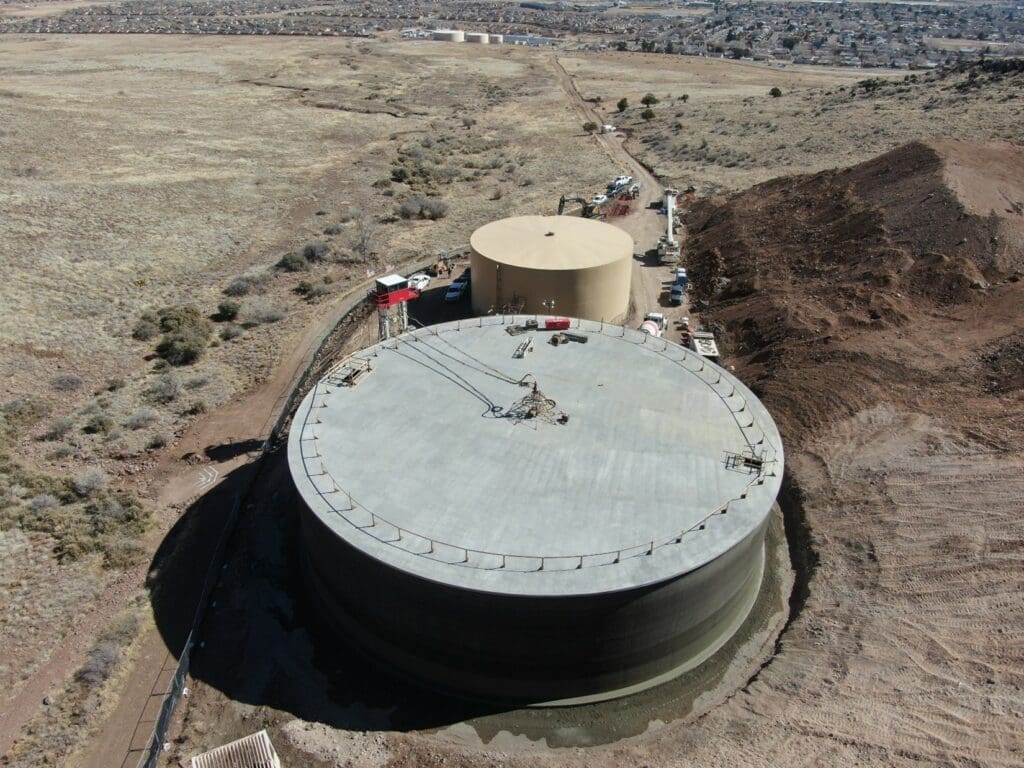 An aerial view of a large water tank in the desert.