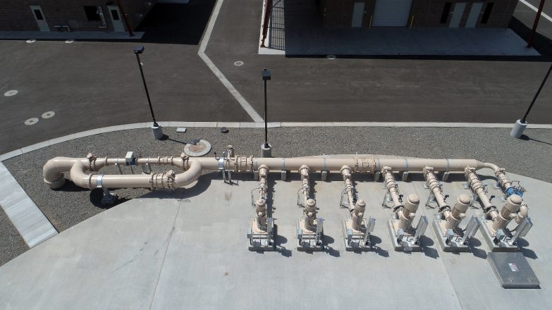 An aerial view of a group of pipes in a parking lot.